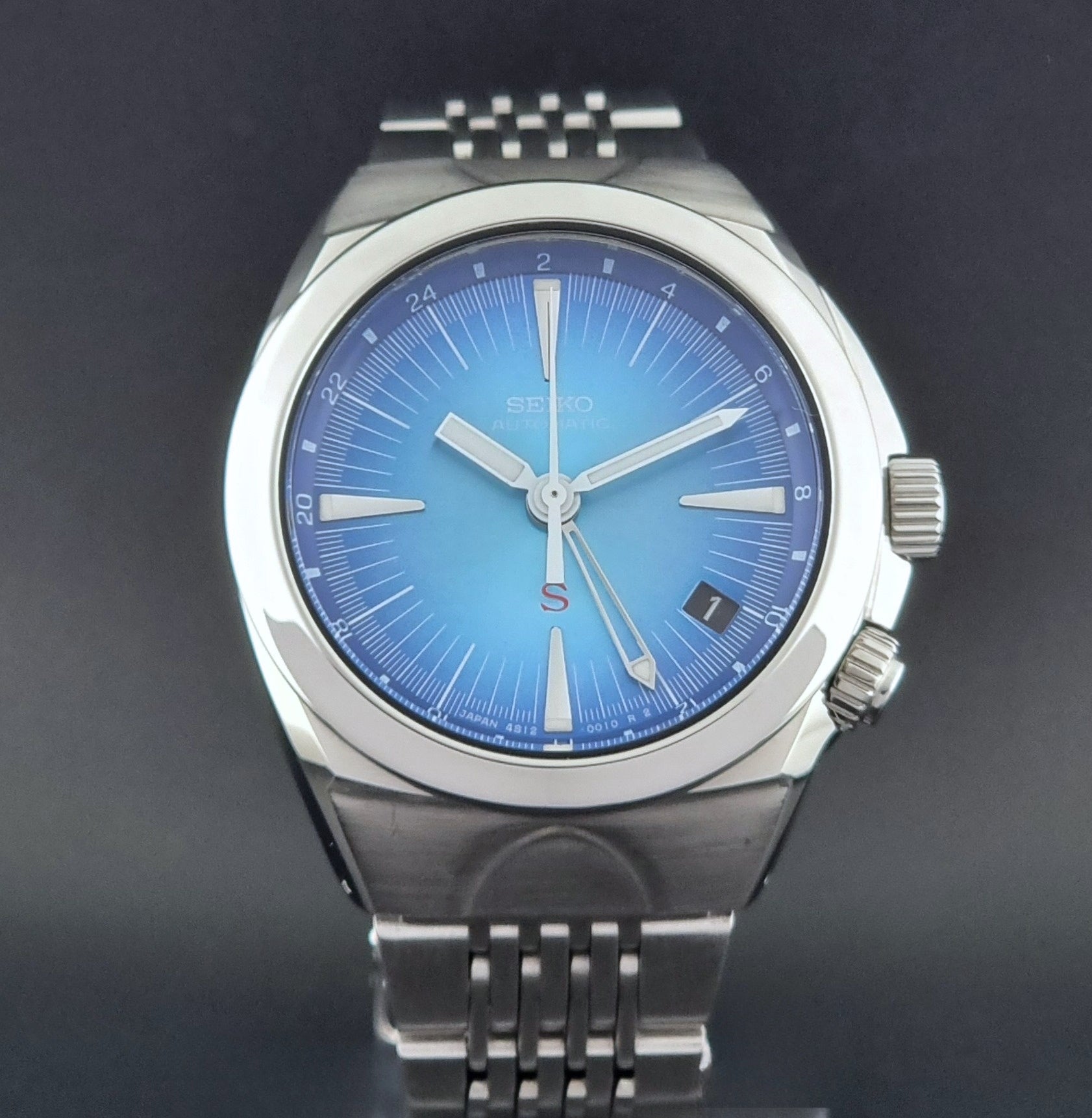 Seiko watch Mechasus SCFF009 GMT 4S12-0010 with a blue face on a dark gray background close dial view