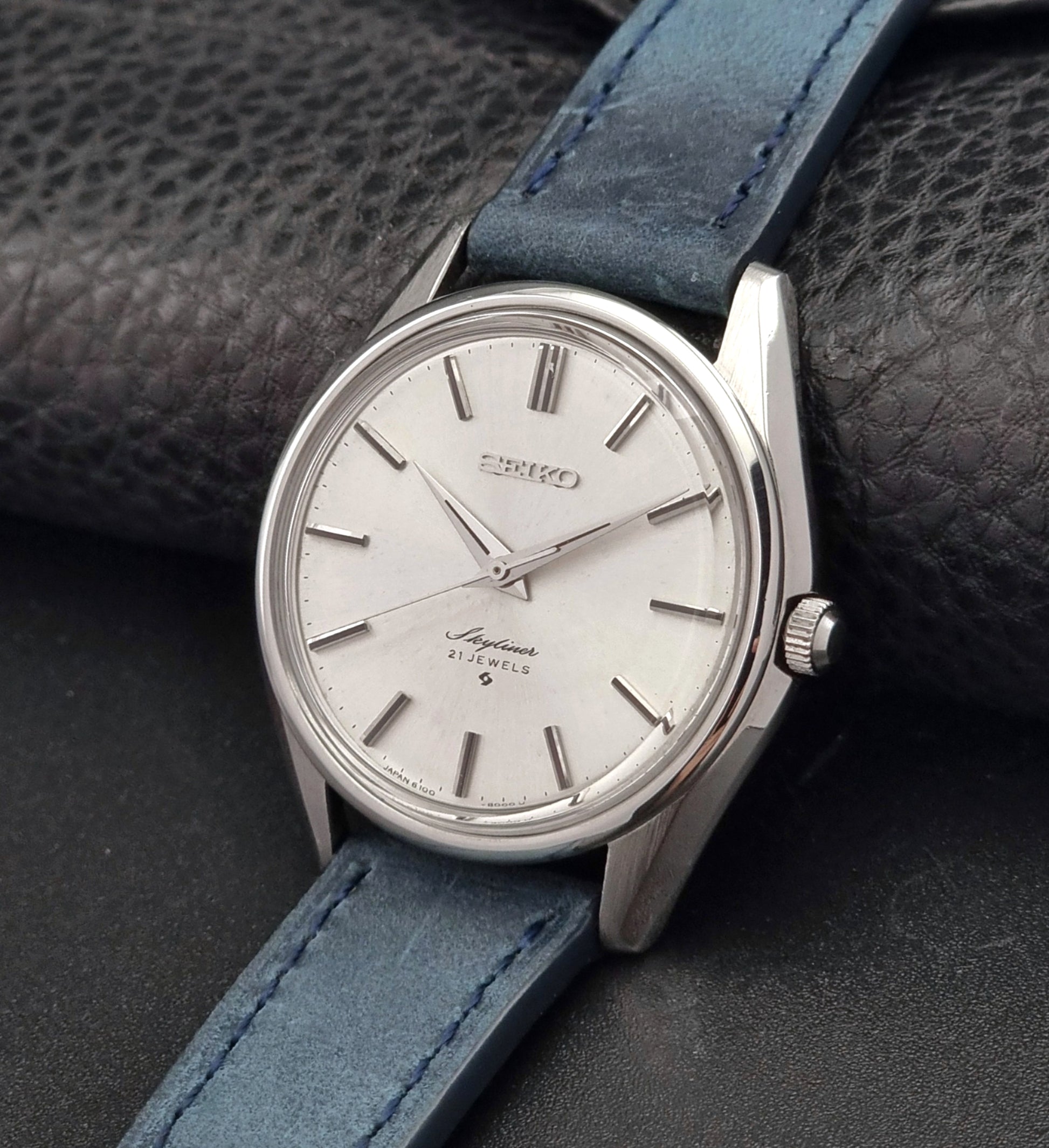 Vintage Seiko Skyliner 6100-8000 watch with blue leather strap on a dark textured background