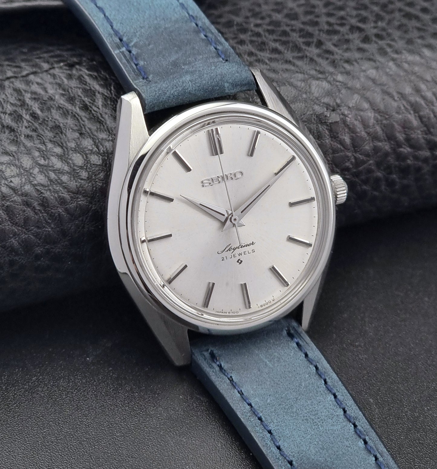 Seiko Skyliner 6100-8000 watch with blue leather strap on a textured surface