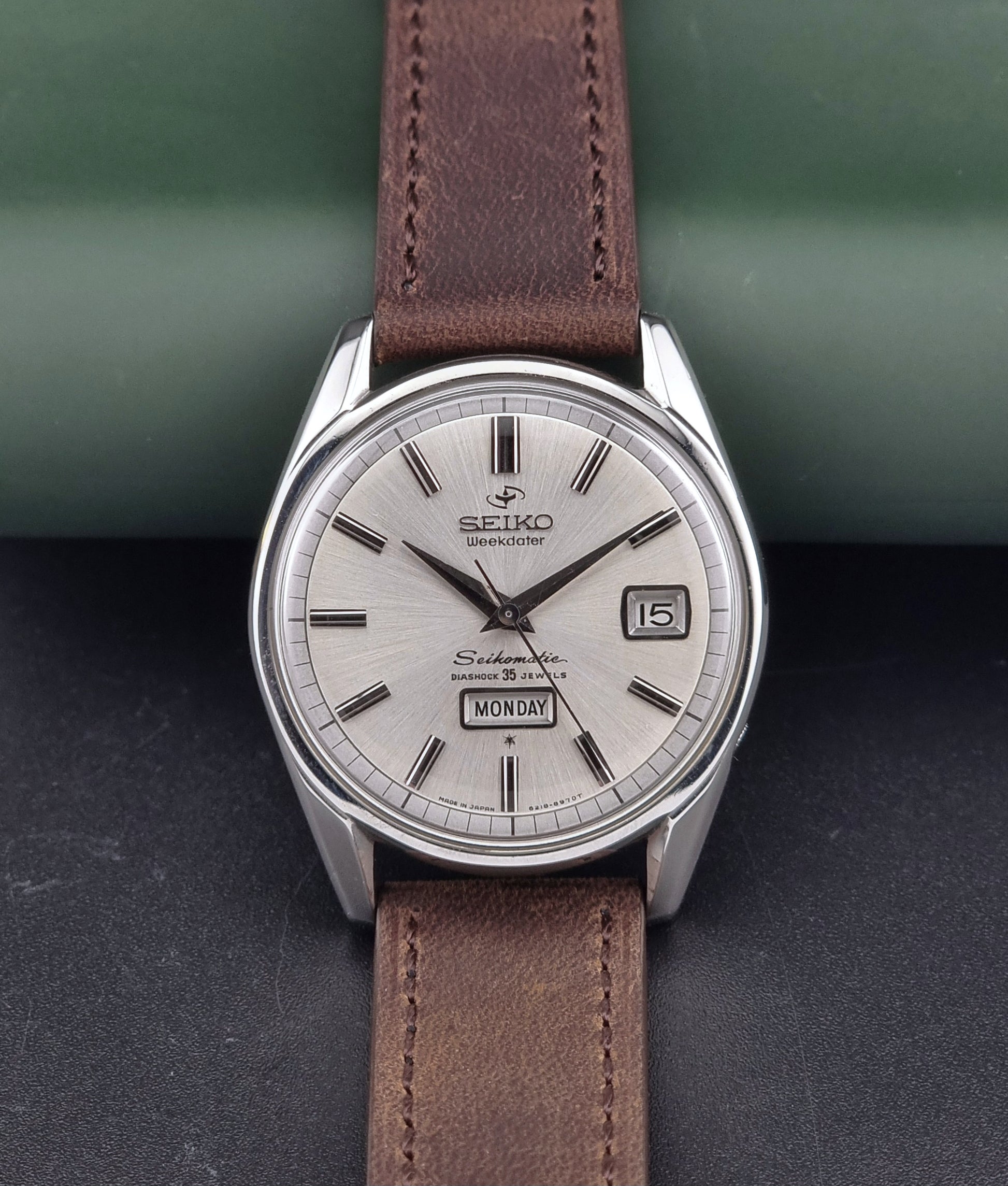 Vintage Seiko watch with brown leather strap on a dark surface
