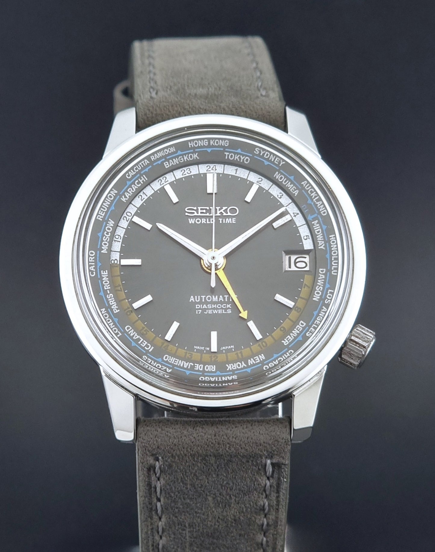 Vintage Seiko Wristwatch World Time 6217-7000 gray leather strap and dark gray dial on a dark background front view