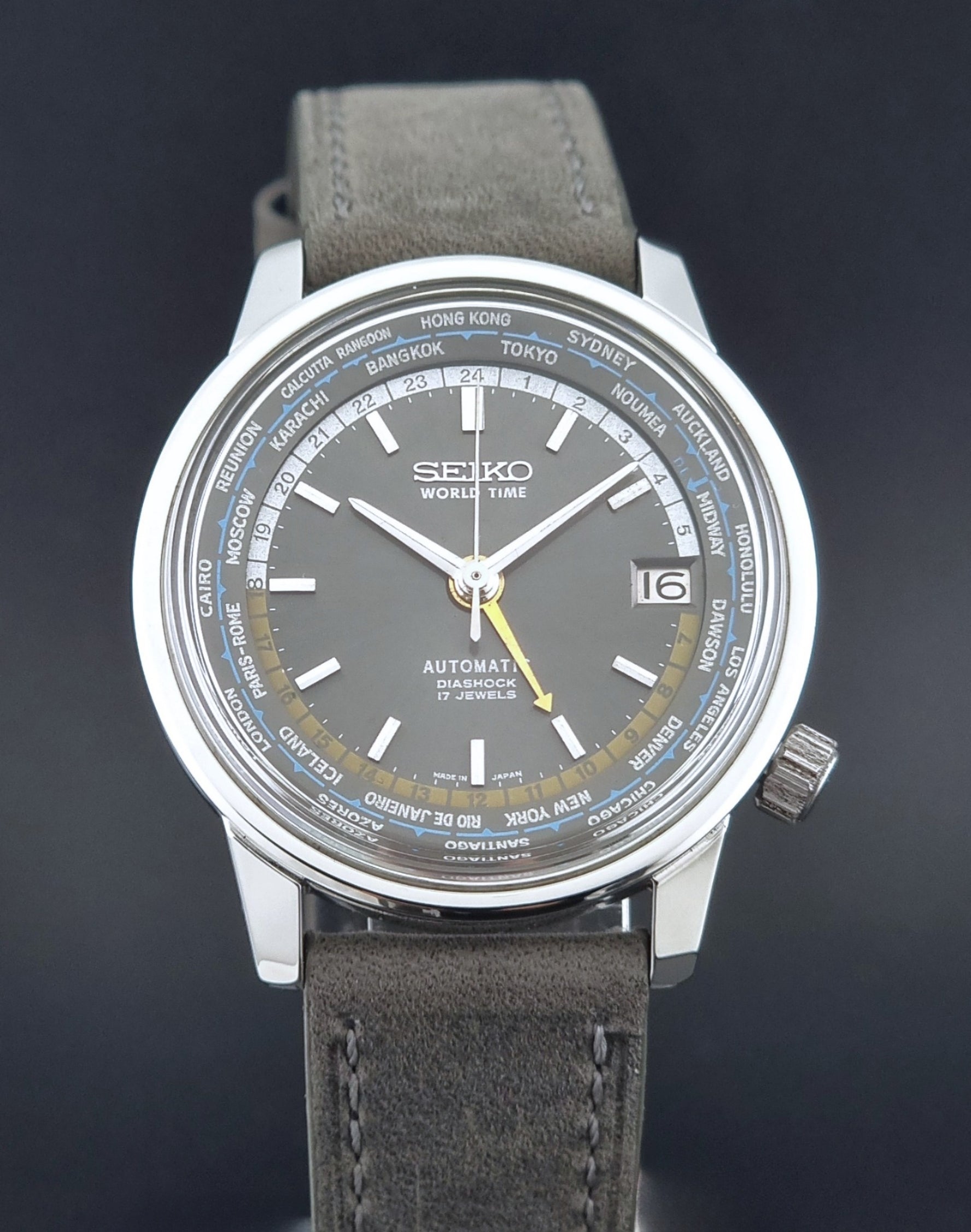 Vintage Seiko Wristwatch World Time 6217-7000 gray leather strap and dark gray dial on a dark background front view