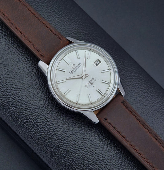 Vintage Seiko Wristwatch Seikomatic J13085 brown leather strap on a dark textured surface front