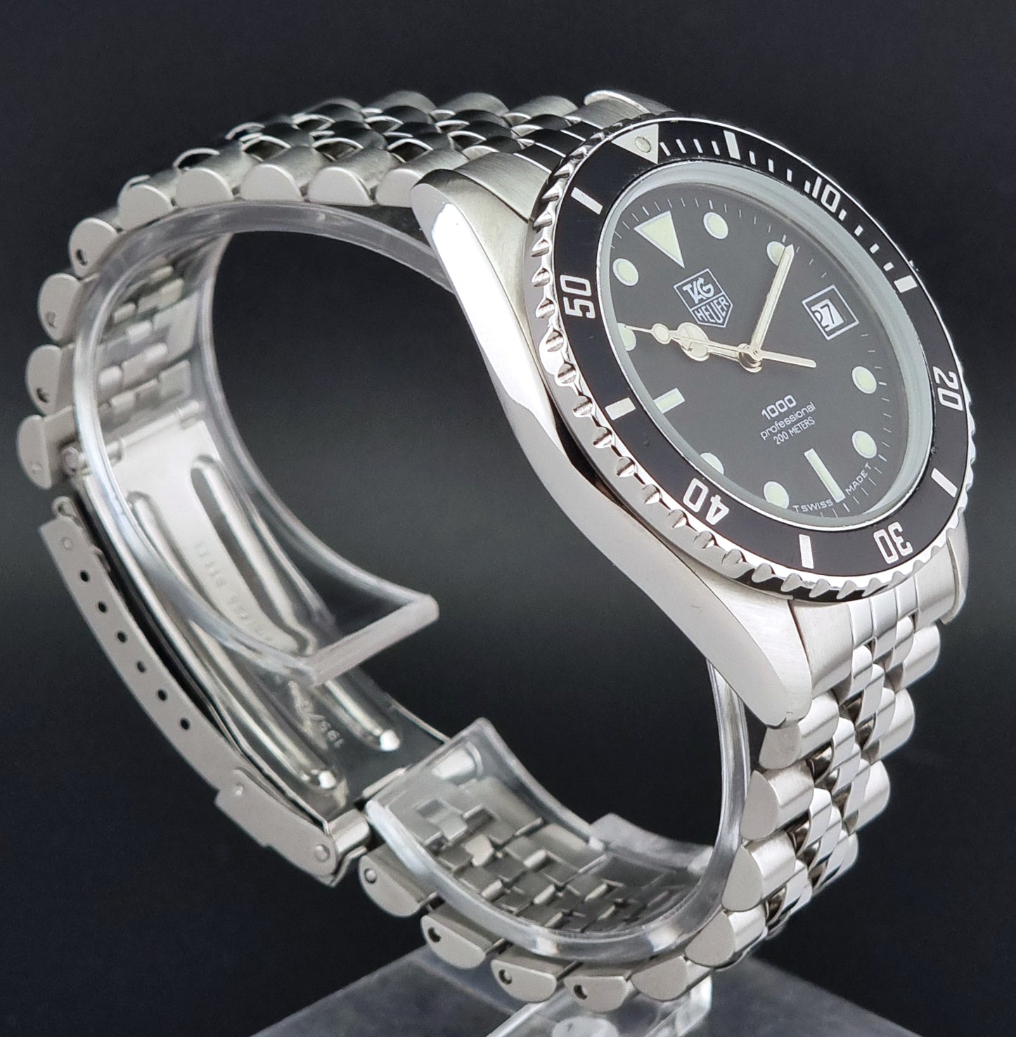 Vintage Tag Heuer Wristwatch Professional 1000 Quartz 980.013N with a black dial on a dark background close side view