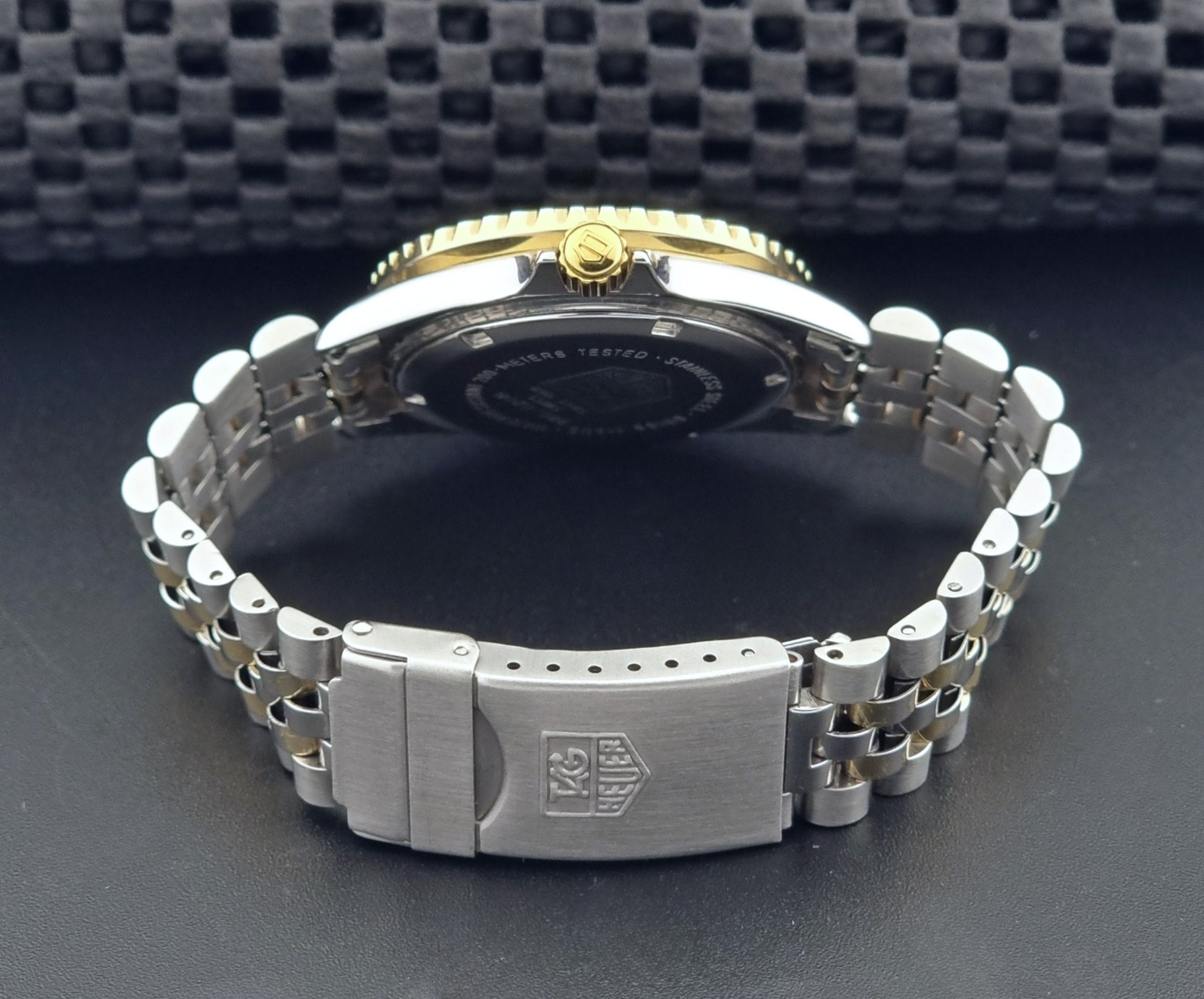Vintage Tag Heuer watch Professional Quartz 1000 Diver 980.020N with silver and gold band on a dark background clasp view