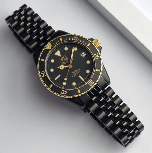 Vintage Tag Heuer watch Professional Quartz 1000 Diver 980.029B black and gold on a light surface dial