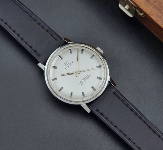 Vintage Tissot Watch Seastar Seven 41545 with a black leather strap on a dark grey surface dial