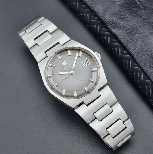 Vintage Tissot Watch 44630 PR 516 with a grey dial on a dark surface front