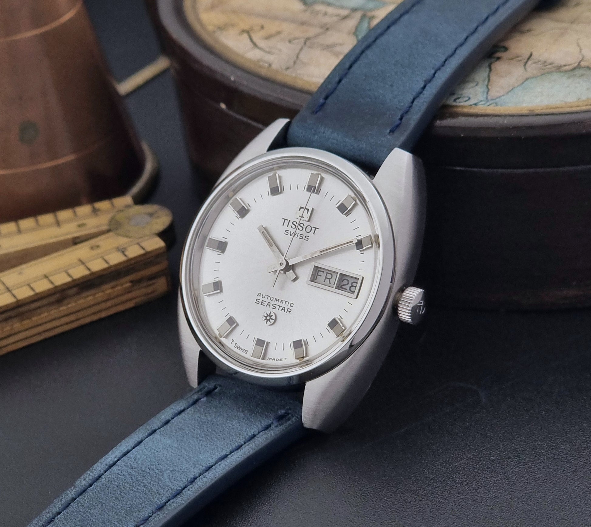 Vintage Tissot Wristwatch Seastar 46660-4Xh with blue strap on a dark surface crown view