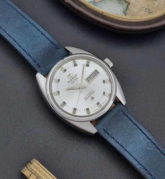 Vintage Tissot Wristwatch Seastar 46660-4Xh with blue strap on a dark surface front