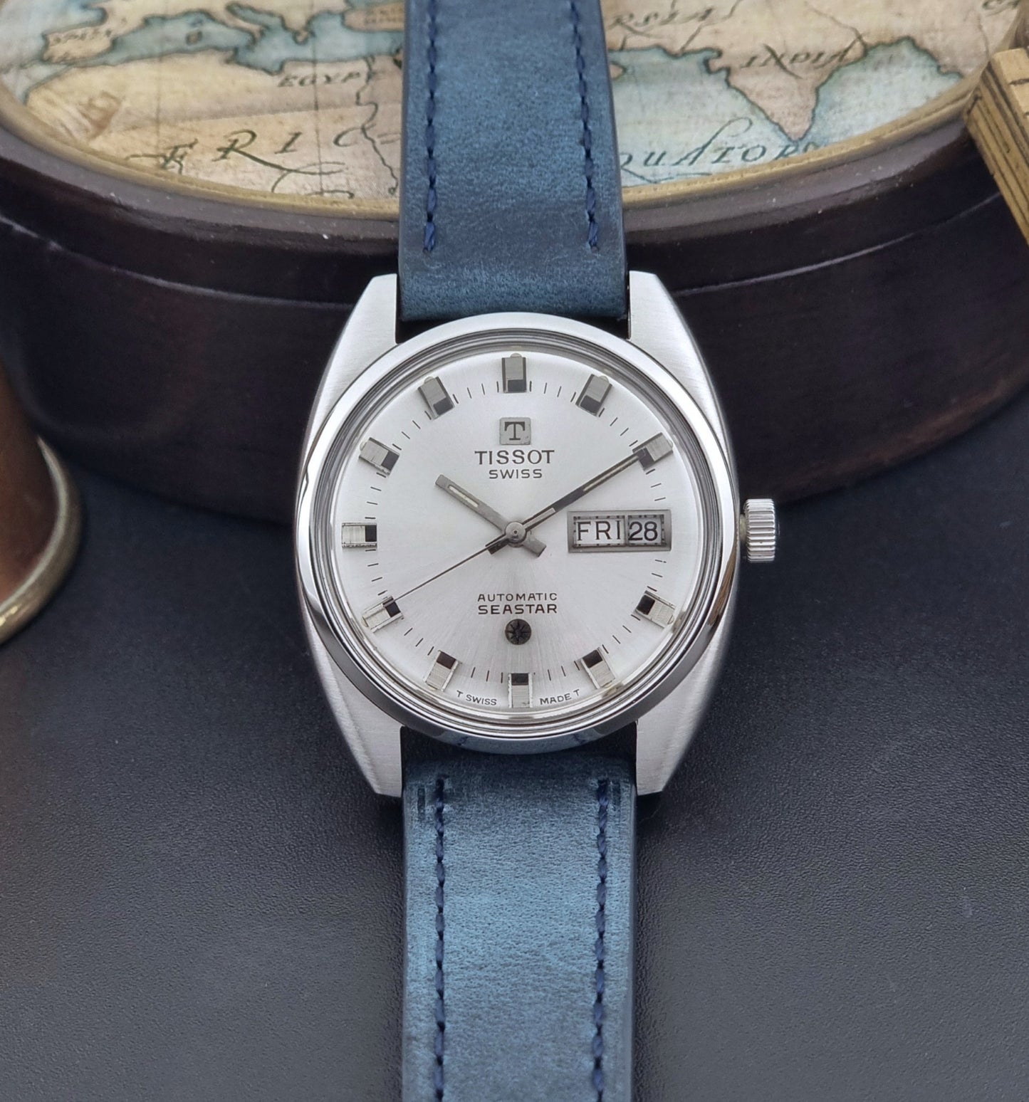 Vintage Tissot Wristwatch Seastar 46660-4Xh with blue strap on a dark surface front view