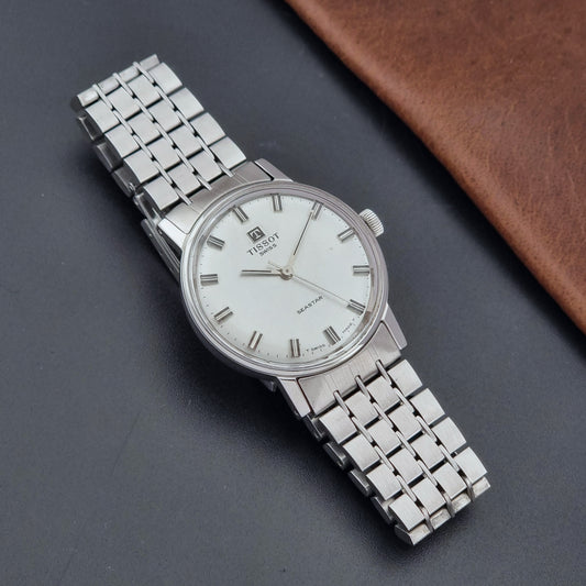 Vintage Tissot Watch Seastar 41520 with a white face on a dark surface dial