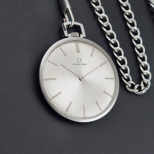 A silver analog pocket watch with a white dial and slim stick indices, shown with its matching silver chain on a dark textured background. The brand name Universal Geneve is visible on the watch face.