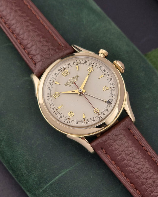Vintage Vulcain cricket W197446 watch with brown leather strap on a green background