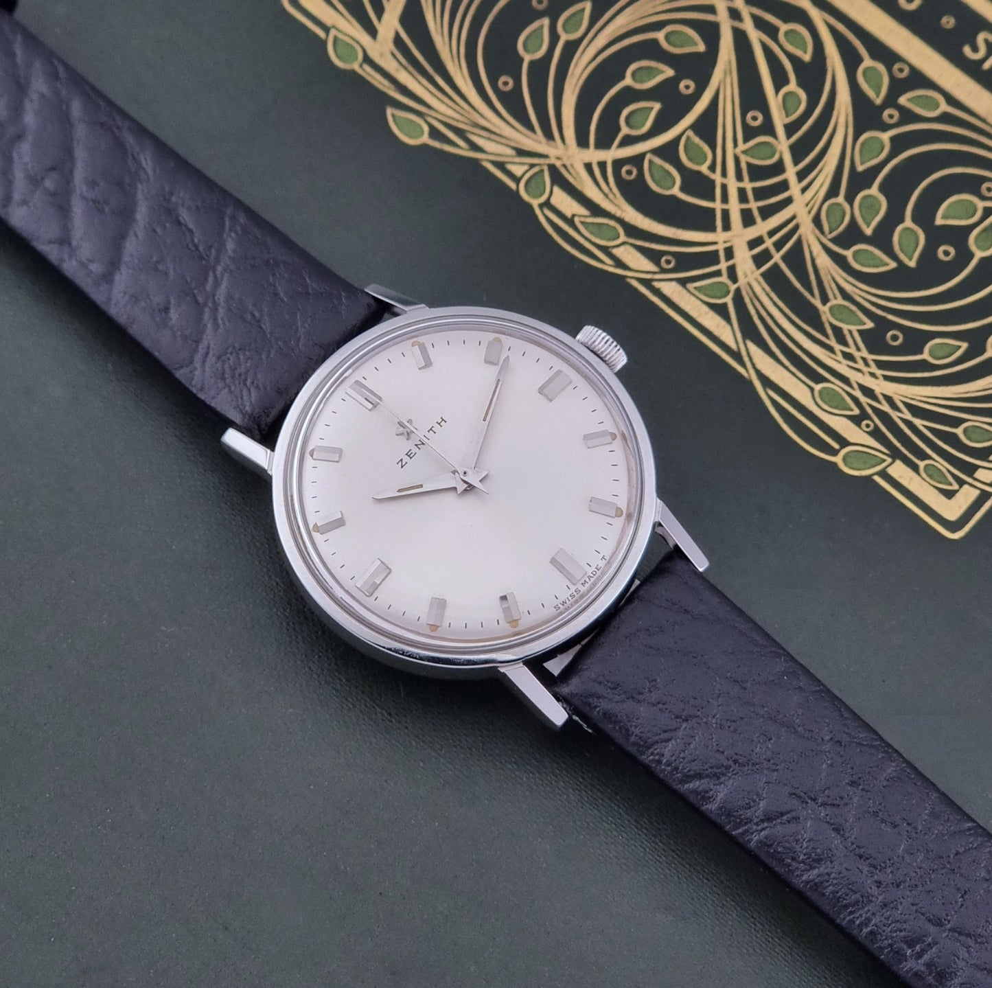 Vintage Unisex Zenith Wristwatch Manual wind with a black strap on a dark background dial