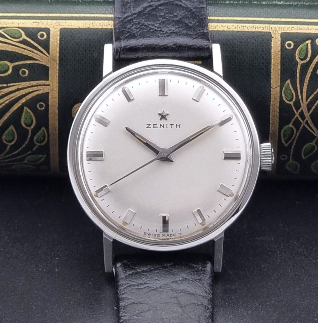 Vintage Unisex Zenith Wristwatch Manual wind with a black strap on a dark background dial view