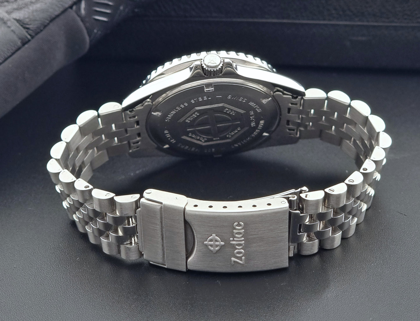 Vintage Zodiac Wristwatch 113.21.03 Quartz with black dial on a dark textured background clasp view