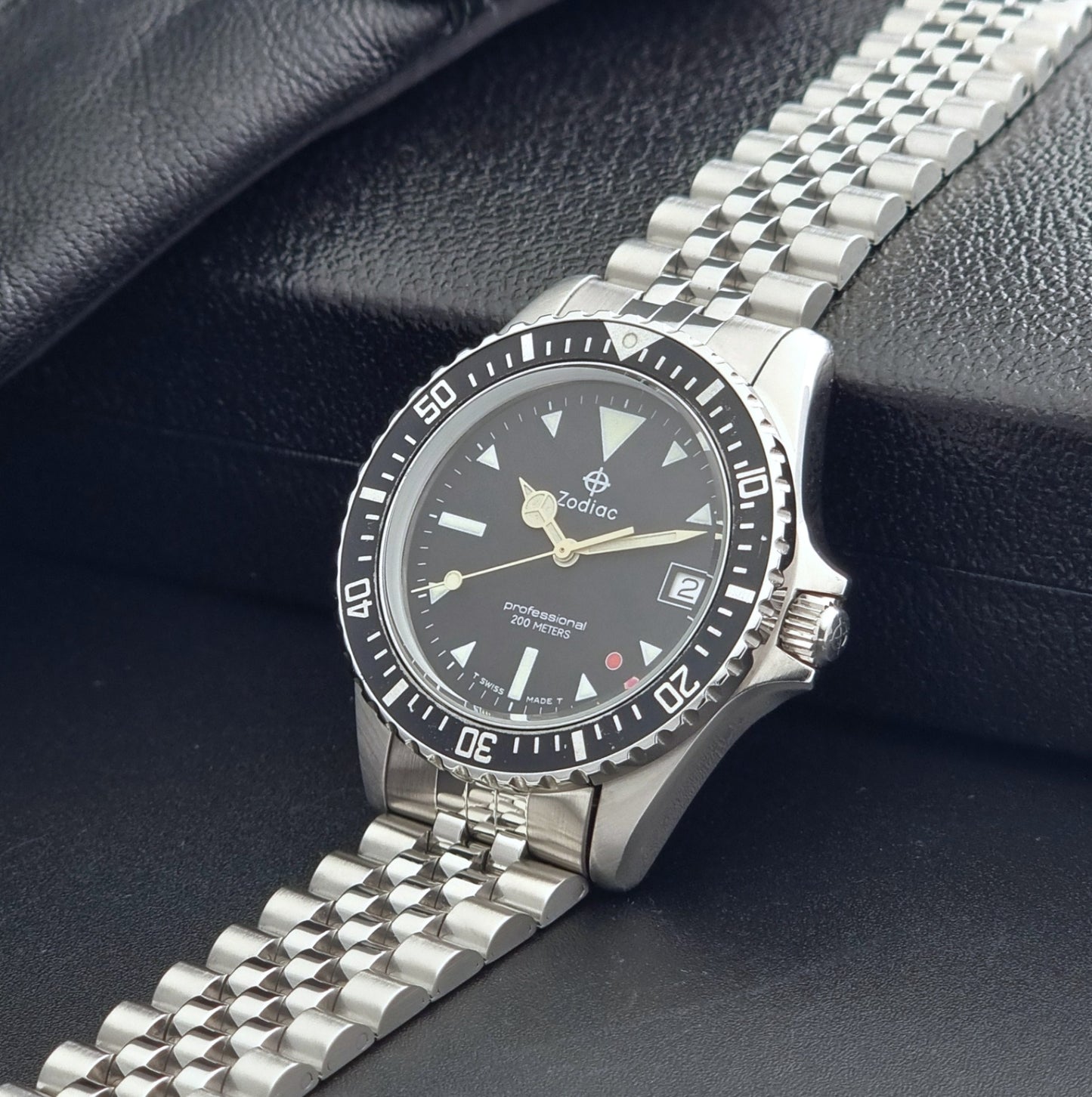 Vintage Zodiac Wristwatch 113.21.03 Quartz with black dial on a dark textured background crown view