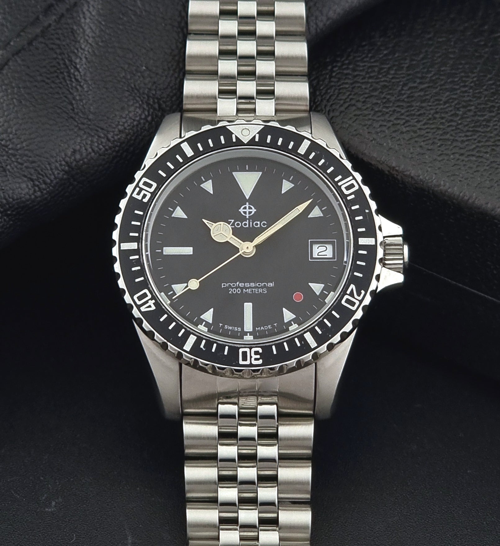 Vintage Zodiac Wristwatch 113.21.03 Quartz with black dial on a dark textured background dial view