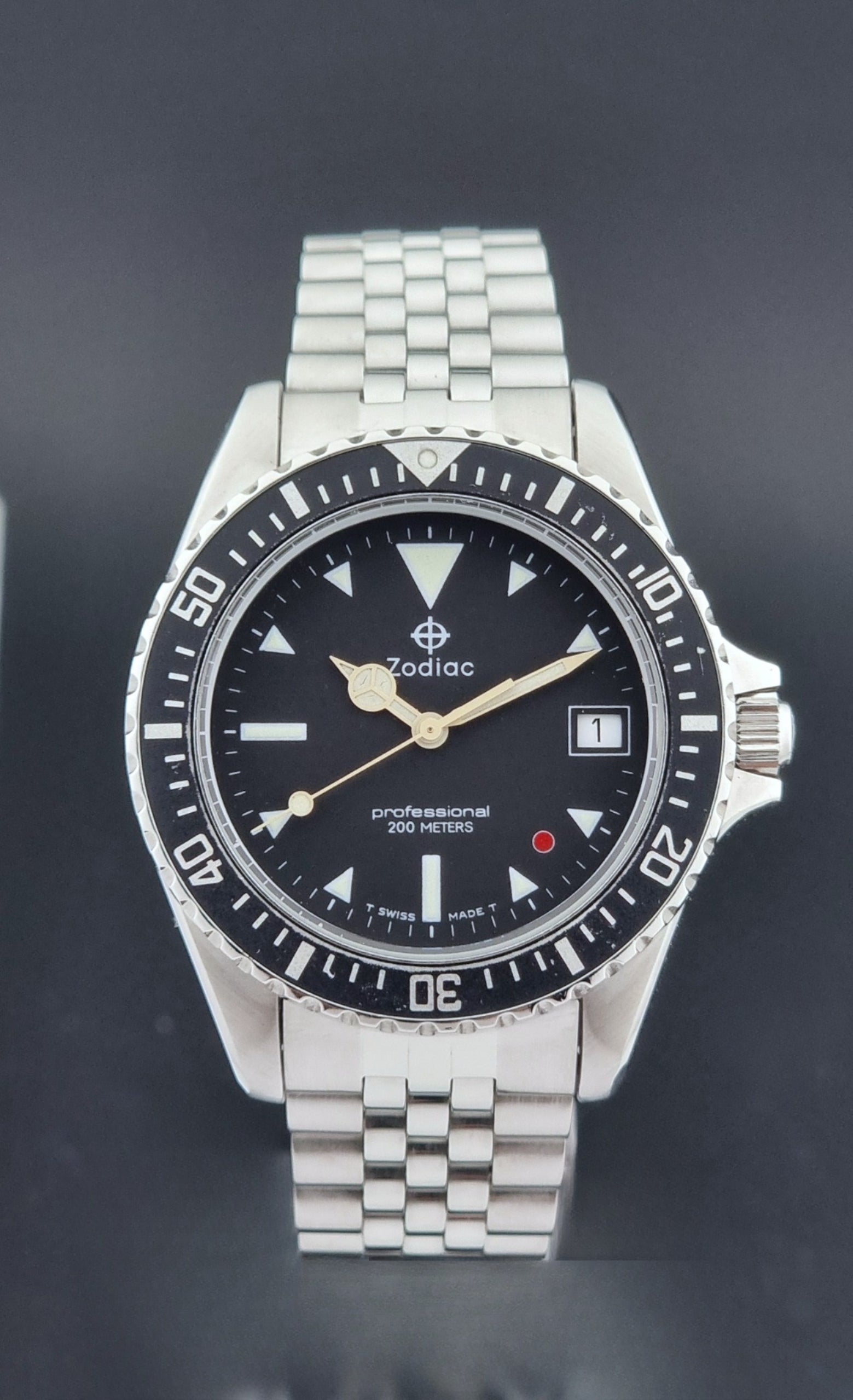 Vintage Zodiac Wristwatch 113.21.03 Quartz with black dial on a dark textured background close up dial