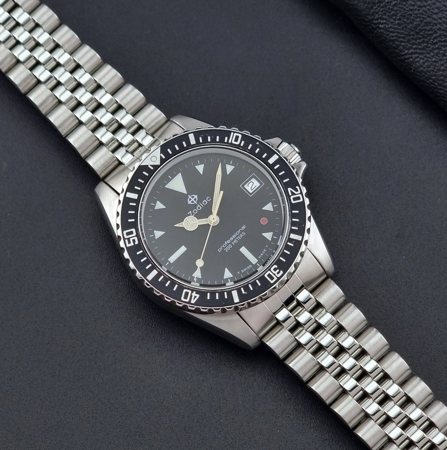Vintage Zodiac Wristwatch 113.21.03 Quartz with black dial on a dark textured background dial