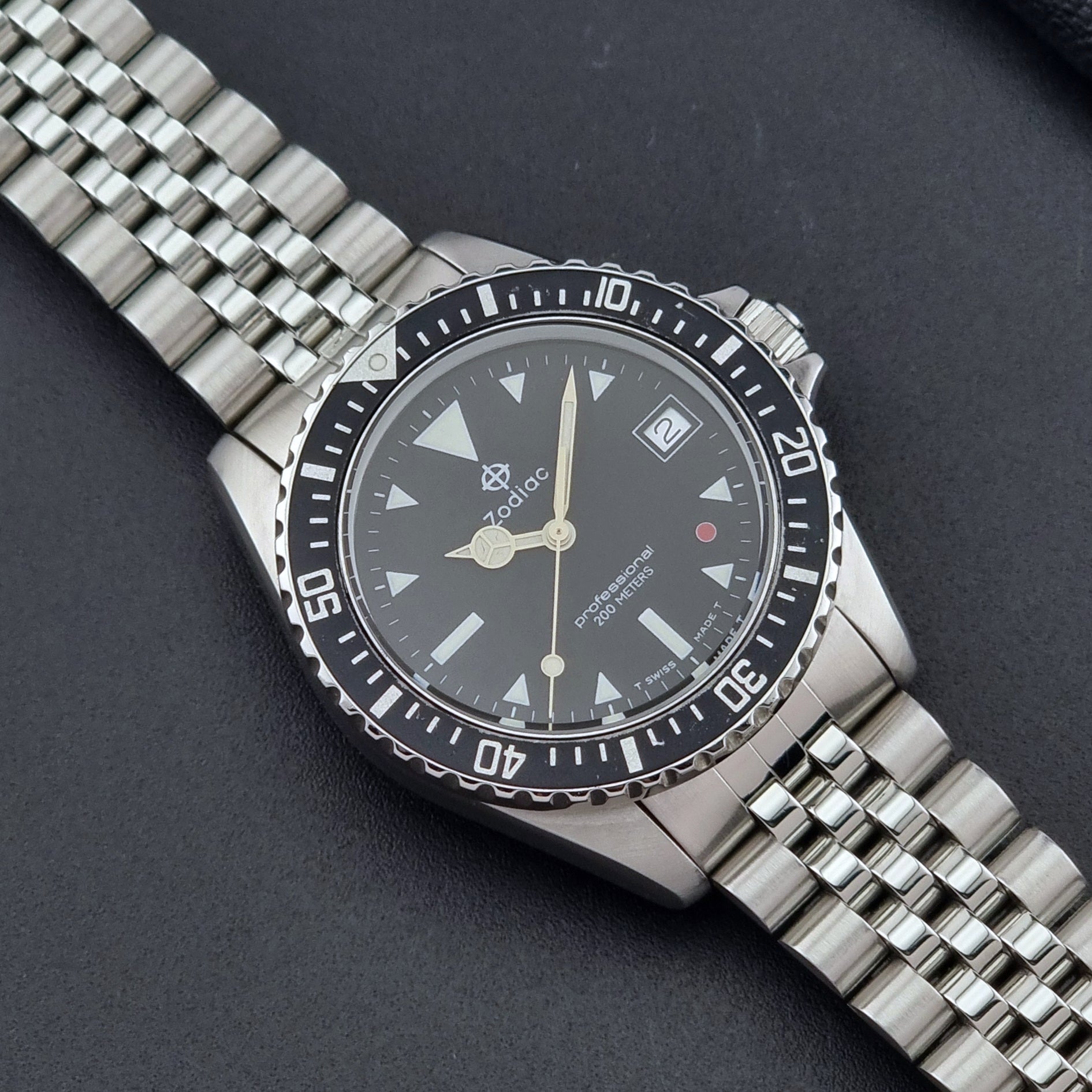 Vintage Zodiac Wristwatch 113.21.03 Quartz with black dial on a dark textured background close up dial view